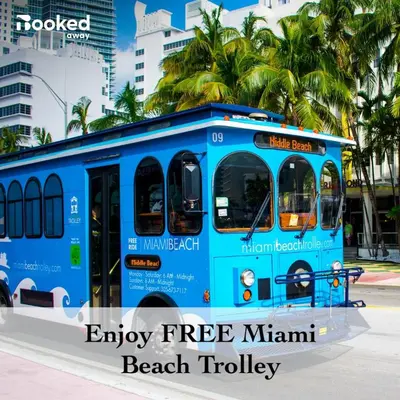 a blue bus is parked on a street at Newely remodeled apartment only 1 min to the beach! in Miami Beach