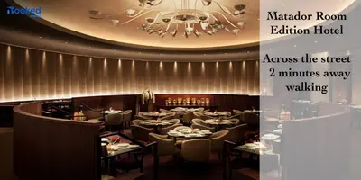 a restaurant with tables and chairs and a chandelier at Steps to the beach! in Miami Beach