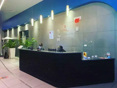 a restaurant with a counter with people sitting at it at Ocean Breeze & City Style, Miami Beach Luxury Stay -A in Hallandale Beach