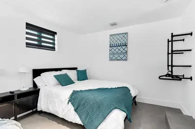 a white bedroom with a bed and a desk at Heated Pool Modern 5 Bedrooms House 10 minutes to the Ocean in Miami