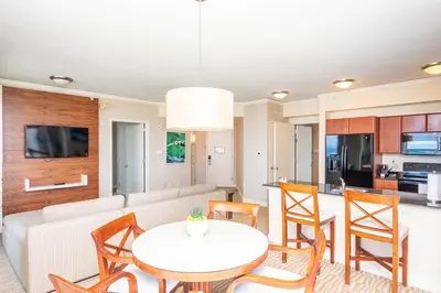 a kitchen and living room with a table and chairs at TRUMP INTERNATIONAL BEACH RESORT 2 BEDROOM APARTMENT 1600 Sqf Ocean and Bay View in Miami Beach