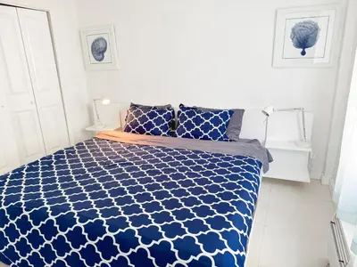 a blue and white bed in a white bedroom at 2 BEDROOM ON THE BEACH ! in Miami Beach