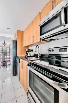 a kitchen with a stainless steel oven and a microwave at Amazing condo 5 minute walk to the beach! in Miami Beach