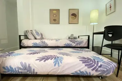 a bedroom with two beds with blue and white sheets at Heart of Miami sleeps 10 near Little Havana Beaches in Miami