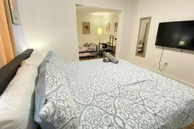 a bedroom with a bed and a flat screen tv at Heart of Miami sleeps 10 near Little Havana Beaches in Miami