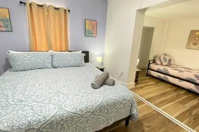 a bedroom with a bed and a couch at Heart of Miami sleeps 10 near Little Havana Beaches in Miami