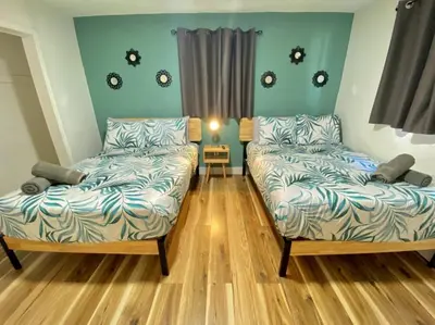 two beds and a couch in a room at Lively Home near Downtown, stadium, Wynwood in Miami