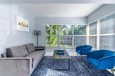 a living room with a couch and a table and chairs at Villa Aura Heated Pool 4 Bedrooms 5 minutes to the Ocean in Fort Lauderdale