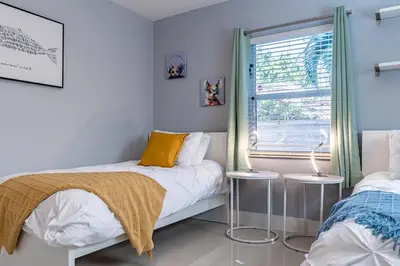 a bedroom with two beds and a window at Villa Aura Heated Pool 4 Bedrooms 5 minutes to the Ocean in Fort Lauderdale