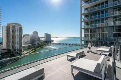 a balcony with chairs and a view of the ocean at Water front Icon Brickell, W Hotel building in Miami