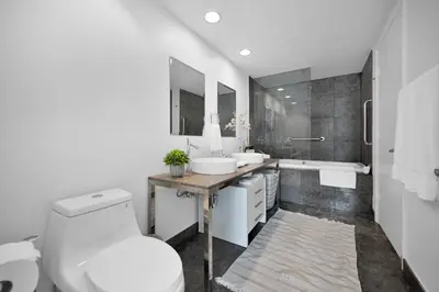 a bathroom with a toilet and a sink and a tub at Water front Icon Brickell, W Hotel building in Miami
