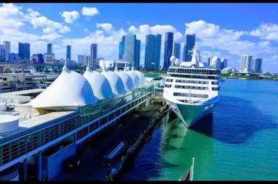 a cruise ship docked at a dock with a city at NEW Luxurious Studio Private in the heart of Miami in Miami