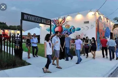 a group of people walking in front of a building at NEW Luxurious Studio Private in the heart of Miami in Miami