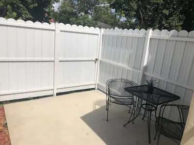 a patio with a white fence with a table and chairs at NEW Luxurious Studio Private in the heart of Miami in Miami