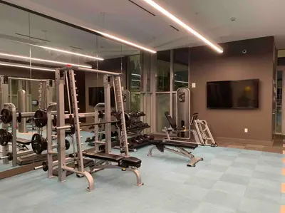 a gym with several tread machines in a room at Luxury Oceanview Studio at Miami Design District in Miami