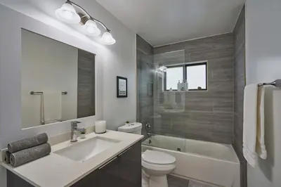 a bathroom with a sink and a toilet and a tub at Top Location Villa at Highland Lakes Blvd BY THE GLAMHOMES in Miami