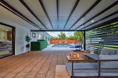 a living room with a patio and a swimming pool at Top Location Villa at Highland Lakes Blvd BY THE GLAMHOMES in Miami