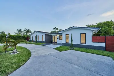 a rendering of a house with a driveway at Top Location Villa at Highland Lakes Blvd BY THE GLAMHOMES in Miami