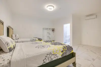 a bedroom with a bed with a comforter on it at Stylish Fort Lauderdale Home 5 Mi to Beach! in Fort Lauderdale