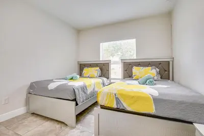 two twin beds in a room with a window at Stylish Fort Lauderdale Home 5 Mi to Beach! in Fort Lauderdale