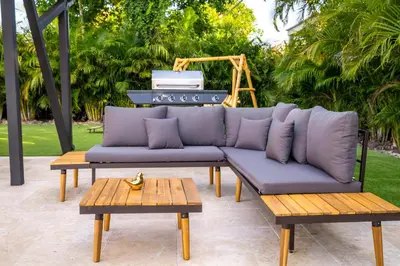 a couch sitting on a patio with two tables at Amazing Villa at Highland Lakes Boulevard BY THE GLAMHOMES in Miami