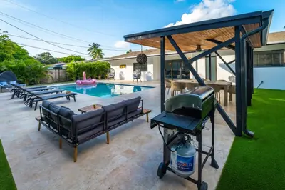 a backyard with a swimming pool and a grill at Amazing Villa at Highland Lakes Boulevard BY THE GLAMHOMES in Miami