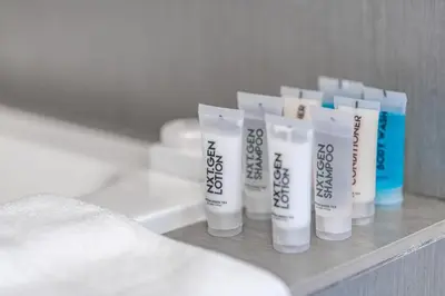 a row of toothbrushes sitting on a shelf in a bathroom at Churchill Suites Monte Carlo Miami Beach in Miami Beach