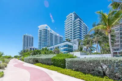 a sidewalk in front of a city with tall buildings at Churchill Suites Monte Carlo Miami Beach in Miami Beach