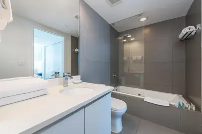 a bathroom with a sink and a toilet and a tub at Churchill Suites Monte Carlo Miami Beach in Miami Beach