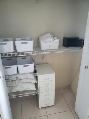a closet with white shelves and boxes on it at Entire Beach Front Condo w/ pool Amazing view 4pax in Miami Beach