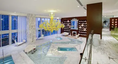 a large room with a pool and a chandelier at Luxury Ocean View 2BR Corner Unit at W residence in Miami