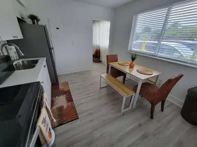 a kitchen and dining room with a table and chairs at Sol Miami #1 with free parking on premises in Miami
