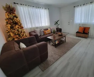 a living room with a christmas tree and a couch at Sol Miami #1 with free parking on premises in Miami