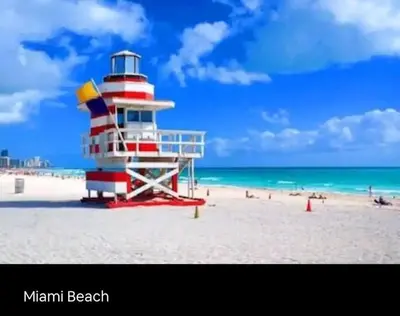 a lighthouse on a beach with people on the beach at Sol Miami # 2 with free parking in Miami