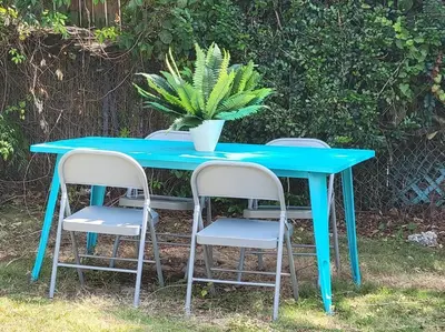 a blue table with three chairs and a plant on it at Sol Miami # 2 with free parking in Miami