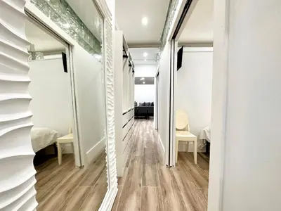 a hallway with mirrors and chairs in a room at Oceanfront 3 Room Ocean Drive Condo in Miami Beach