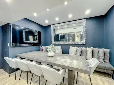 a dining room with a table and white chairs at Oceanfront 3 Room Ocean Drive Condo in Miami Beach