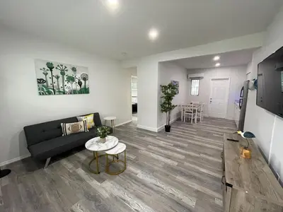 a living room with a couch and a table at Douglas rd apartments in Miami
