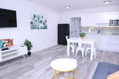 a kitchen and dining room with a table and chairs at Douglas rd apartments in Miami