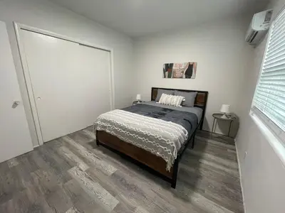 a bedroom with a bed and a sliding door at Douglas rd apartments in Miami