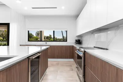 a kitchen with white counters and a large window at Super Modern Waterfront Paradise Near the Beach in Miami