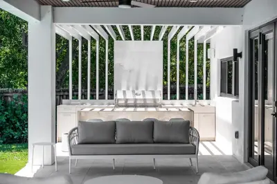 a living room with a couch on a patio at Super Modern Waterfront Paradise Near the Beach in Miami