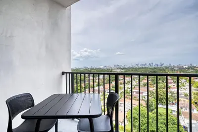 a table and chairs on a balcony with a view at Coral Gables 1br w pool wd nr shops airport MIA-74 in Miami