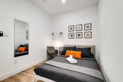 a bedroom with a bed with orange pillows and a mirror at Beautiful Shenandoah One Bedroom Fast Internet Shen3 in Miami