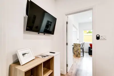 a living room with a flat screen tv on a wall at Beautiful Shenandoah One Bedroom Fast Internet Shen3 in Miami
