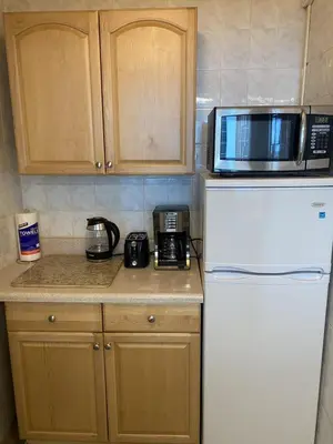a kitchen with a white refrigerator and a microwave at Studio Miami Beach sobre la playa in Miami Beach