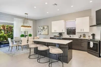 a kitchen with a table and chairs and a dining room at VILLA MAGNOLIA-with heated pool-by VIAC in Fort Lauderdale