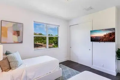 a white room with a white couch and two windows at VILLA MAGNOLIA-with heated pool-by VIAC in Fort Lauderdale
