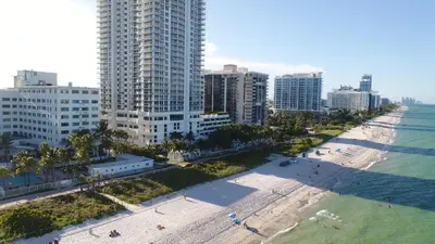 an aerial view of a beach in front of a city at Deluxe Studios and Apartments at the Casablanca in Miami Beach