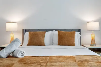 a bedroom with a large bed with two lamps at King David By The Ocean in Miami Beach